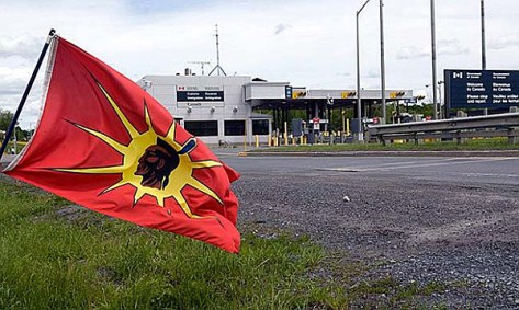 A Mohawk Warrior flag flies in front of a Canadian border crossing station
